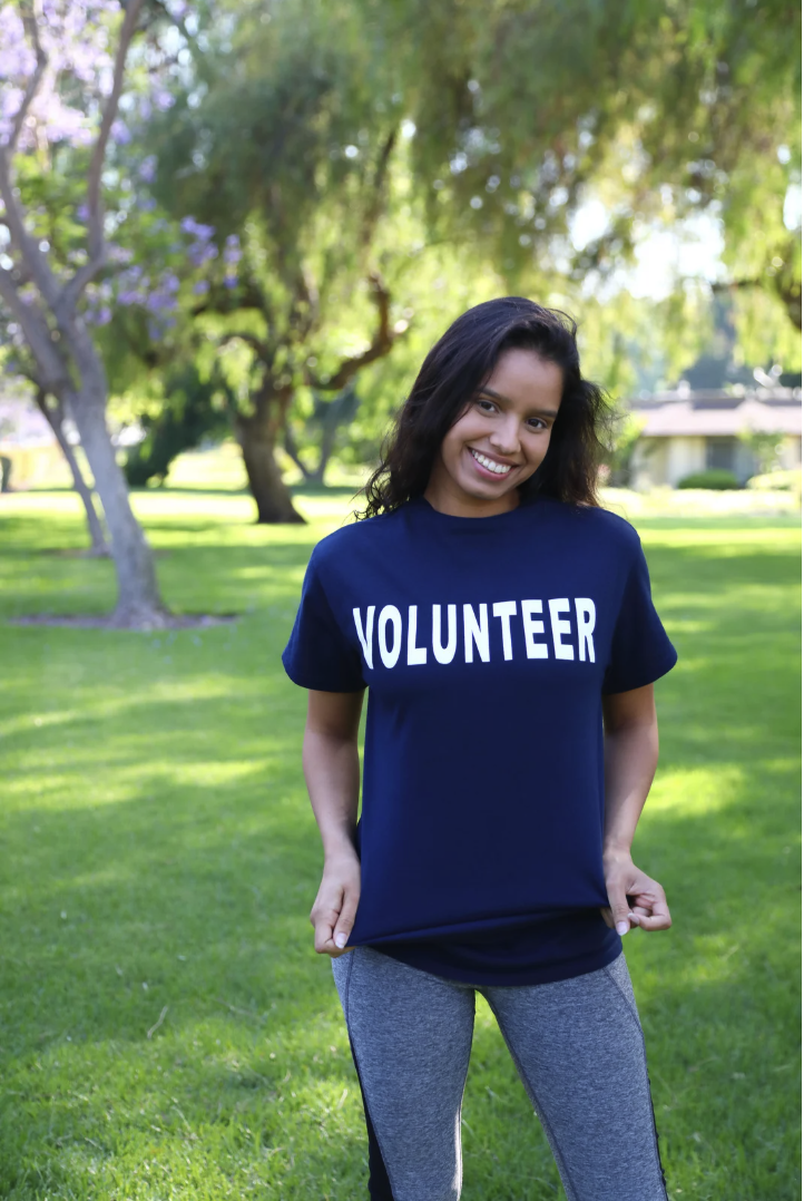 young female wearing blue volunteer t-shirt