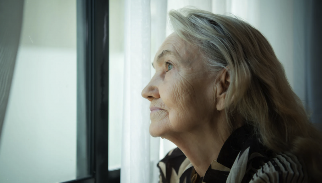Lonely woman staring out a window