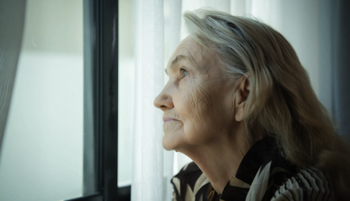 Lonely woman staring out a window