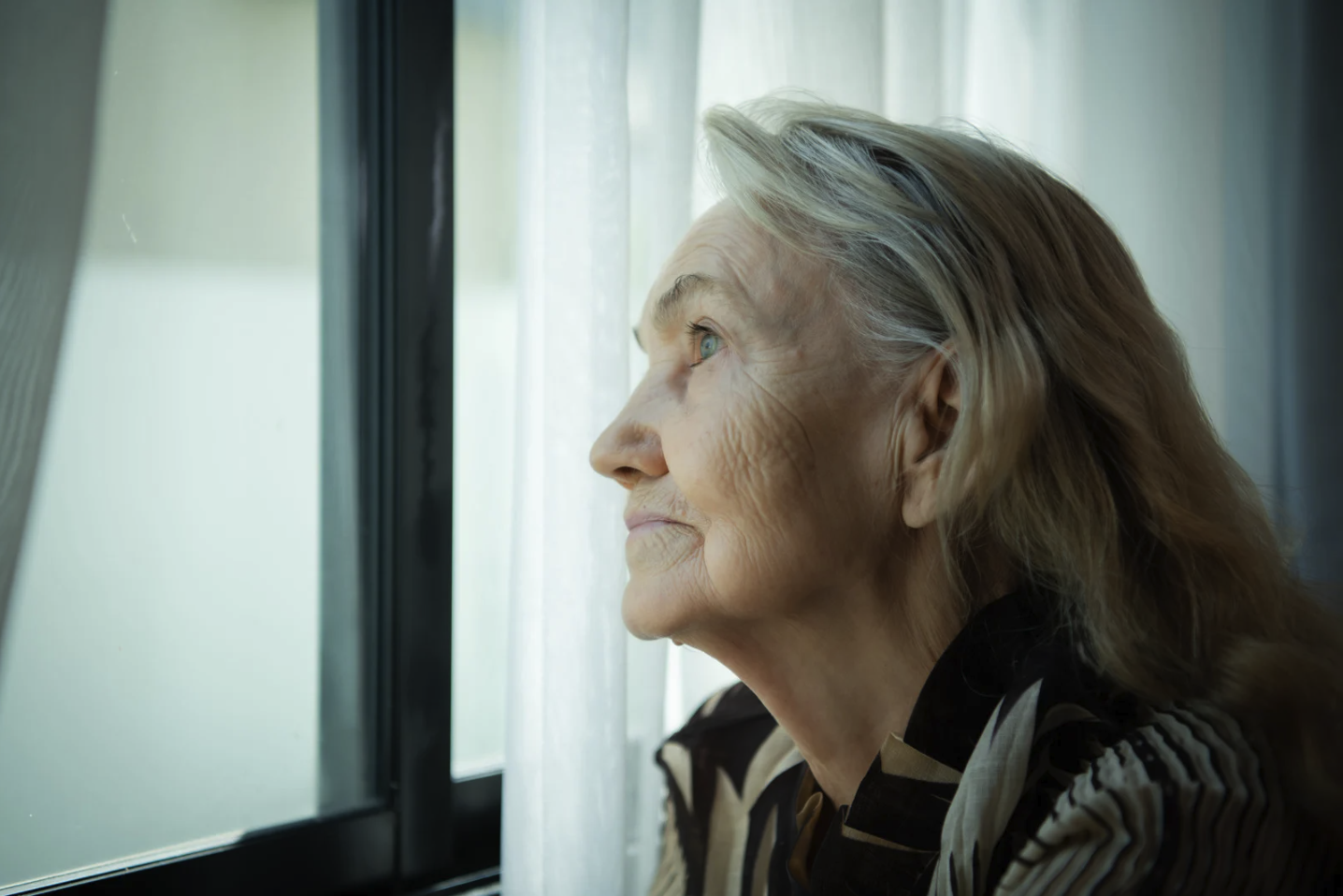 Lonely woman staring out a window