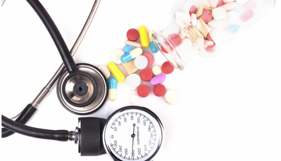 blood pressure cuff and an assortment of pills