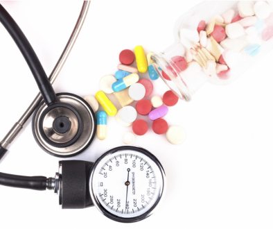 blood pressure cuff and an assortment of pills