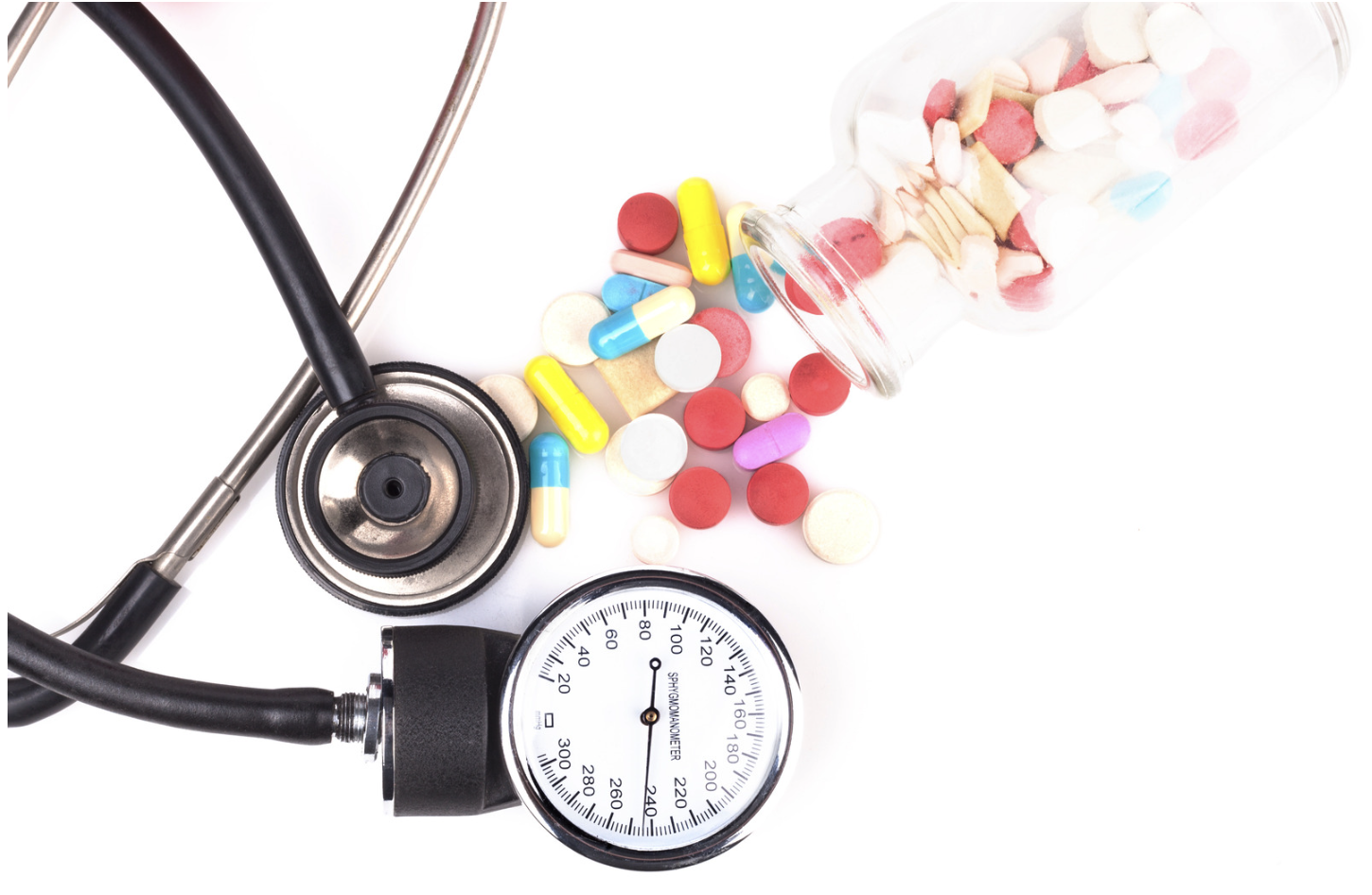 blood pressure cuff and an assortment of pills