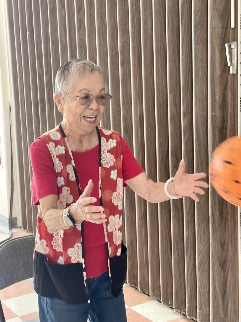 Joyce Fujimoto catching a ball