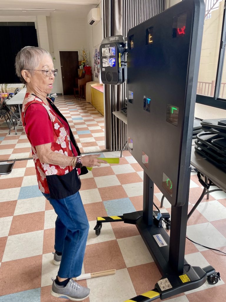 Joyce playing on the SMARTfit machine during a Brain Power class.