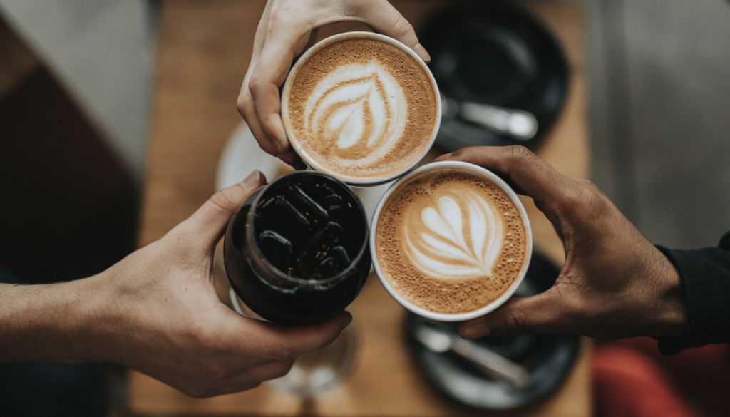 People holding two cups of espresso and one iced coffee