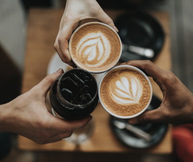 People holding two cups of espresso and one iced coffee