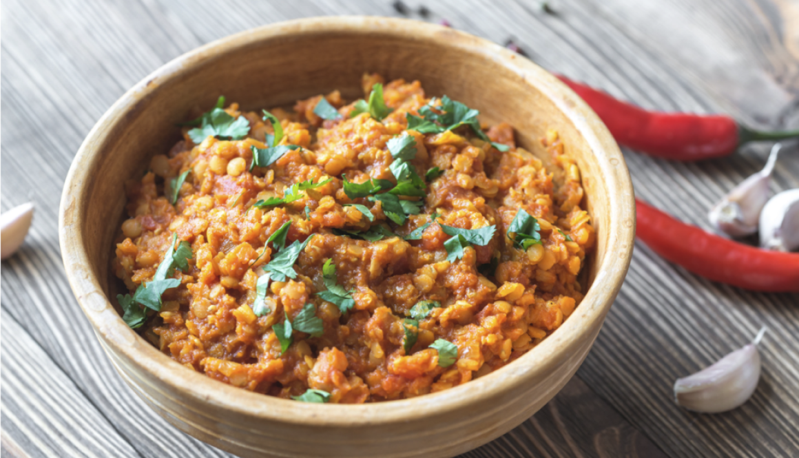 bowl of lentil curry with chopped cilantro as garnish