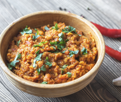 bowl of lentil curry with chopped cilantro as garnish
