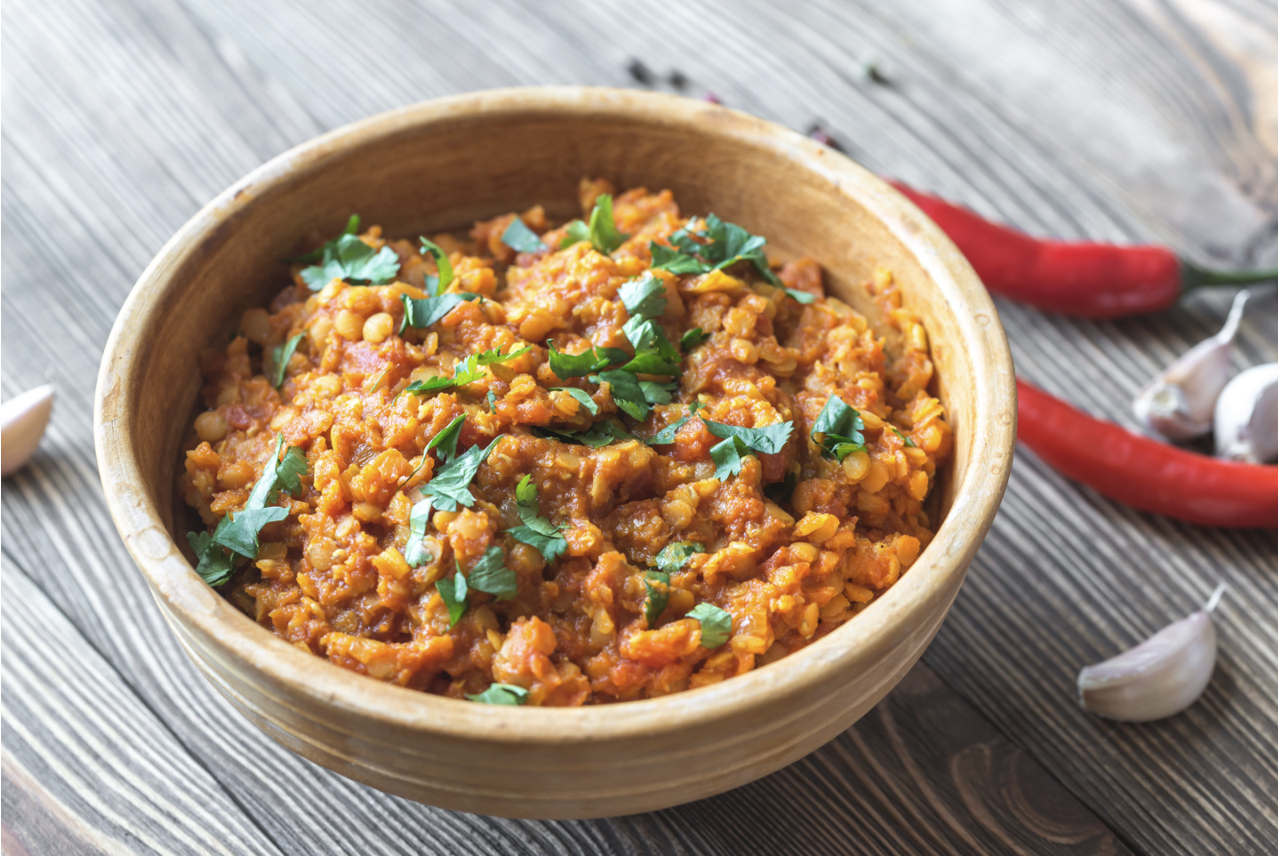 bowl of lentil curry with chopped cilantro as garnish